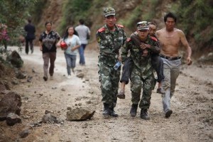 Chinese rescuers carry an injuried resident after an earthquake hit a