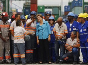 Brazil's President Dilma Rousseff poses with workers during the inauguration ceremony of the Porto do Futuro (Port of Future), a new area of Rio de Janeiro's port