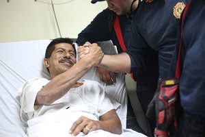 Pablo Rafael Cordova Caizares shakes hands with one of the Colombian firefighters who rescued him, at the Verdi Cevallos Balda hospital in Portoviejo, Ecuador, Monday, April 18, 2016. The 51-year-old hotel administrator was one of a trickle of survivors pulled from the rubble after Ecuador's strongest earthquake in decades flattened towns along the coast and killed hundreds. (AP Photo/Emilio D. Garcia) -----