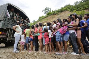 Victims of the 7.8 magnitude earthquake line up to get emergency food and clothing from an army truck in Cholote, Ecuador, Thursday, April 21, 2016. The victims walked 45 minutes to make it to the collection point arranged by Ecuadorís armed forces. President Rafael Correa said Ecuador's worst earthquake in decades caused billions of dollars of damage and he is raising sales taxes and putting a one-time levy on millionaires to help pay for reconstruction. (AP Photo/Dolores Ochoa) -----