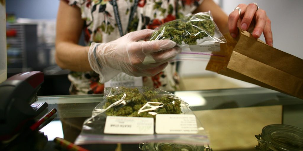 Lakewood, CO - MARCH, 4:  Sales associate, Crystal Guess packages up a patient's cannabis inside a Good Meds medical cannabis center in Lakewood, Colorado, U.S., on Monday, March 4, 2013.   This is at a Good Meds medical cannabis center in Lakewood, and is one of the facilities that Kristi Kelly, Co-Founder of Good Meds Network, operates. (Photo by Matthew Staver/For The Washington Post via Getty Images)