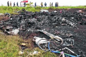 Rescue workers walk at the site of a crashed Malaysia Airlines passen